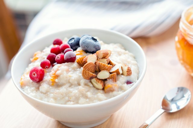 Oatmeal porridge with berries and nuts in bowl