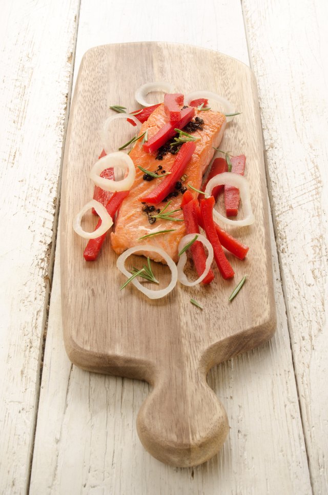 grilled salmon fillet on wooden board