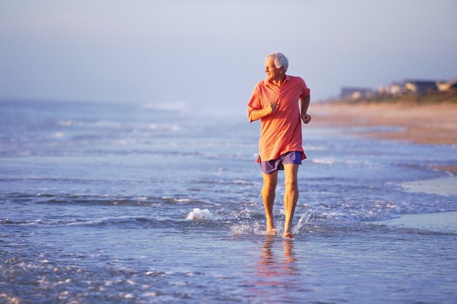 Man jogging in shallow surf