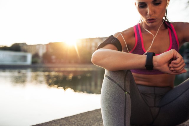 Runner checking her performance on fitness smart watch device