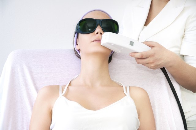 Young woman receiving laser epilation treatment on upper lip