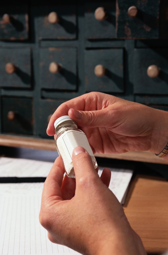 Woman Holding a Bottle of Homeopathic Medicine
