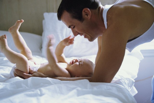 Father playing with baby boy (2-5 months)