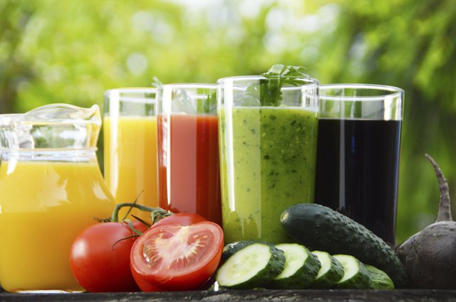 Glasses with fresh vegetable juices in the garden. Detox diet
