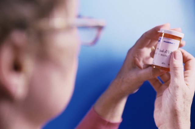 portrait of woman holding out prescription tablets