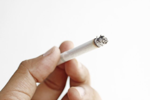 cigarette in hand on white background