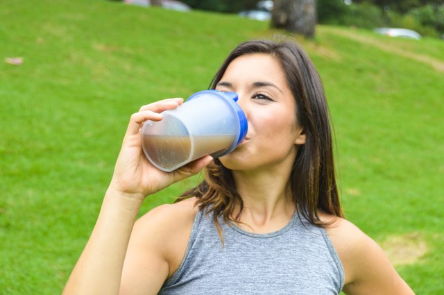 Woman drinking a meal replacement shake (protein shake)