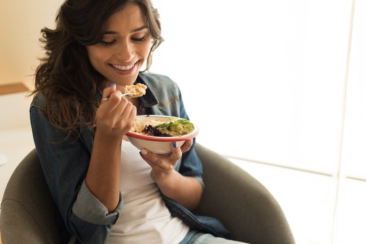 woman eating a salad bowl