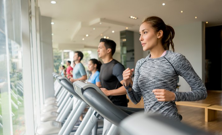 Group of people exercising at the gym on the treadmills