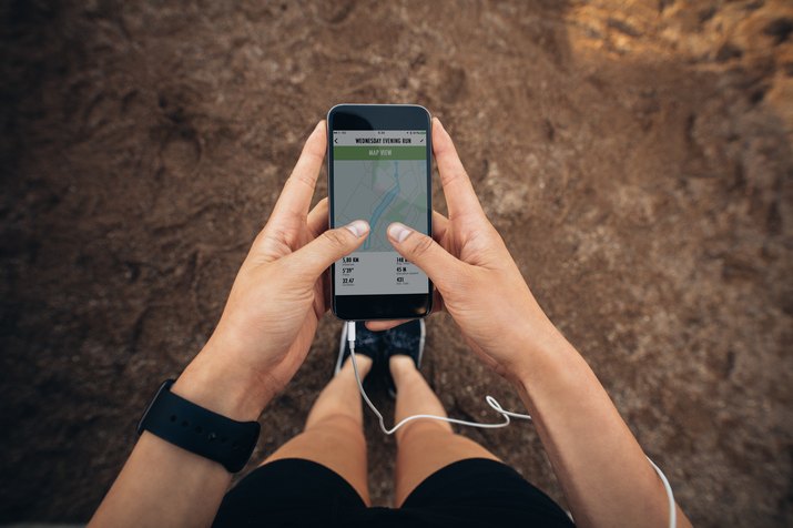 Woman checking the summary of her run on smartphone