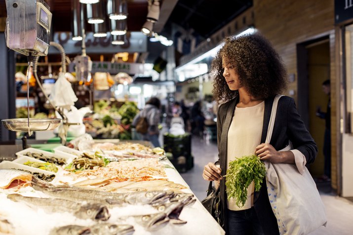 Woman examining fish in market