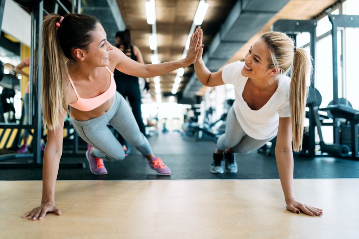 Two attractive fitness girls doing push ups