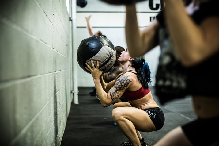Woman doing wall ball exercise in a CrossFit workout