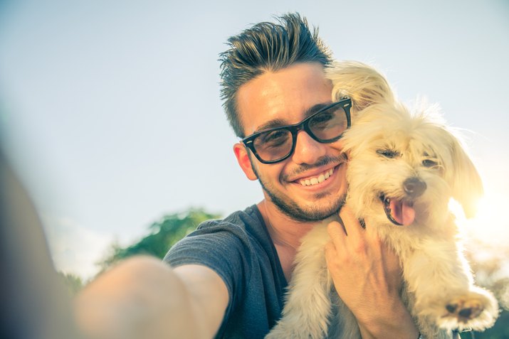 Young man and his dog taking a selfie