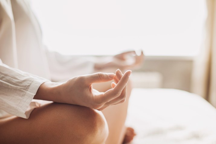 Woman meditating on bed