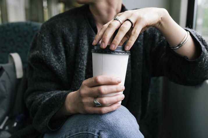 A Woman Holding A Takeout Coffee