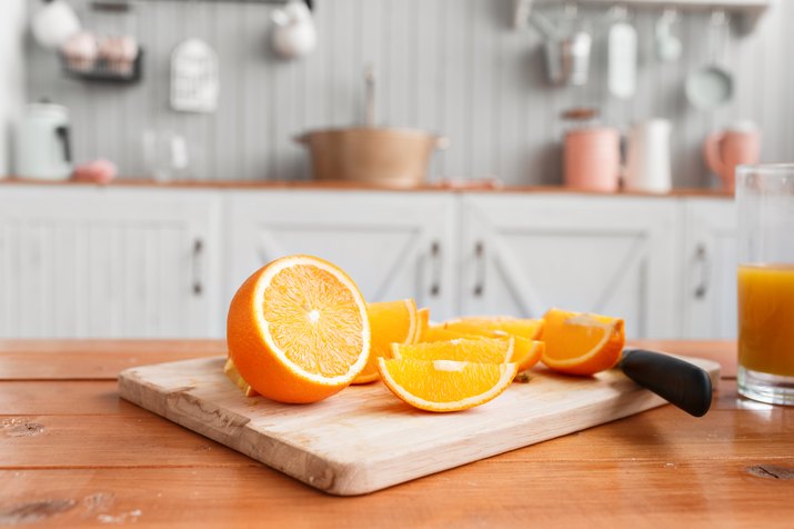 sliced oranges on a wooden cutting board. Healthy and tasty breakfast