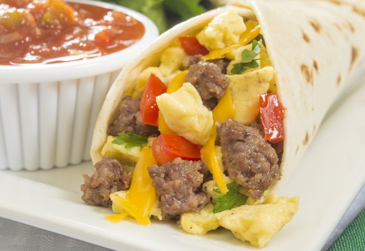 A hot breakfast burrito with egg and sausage