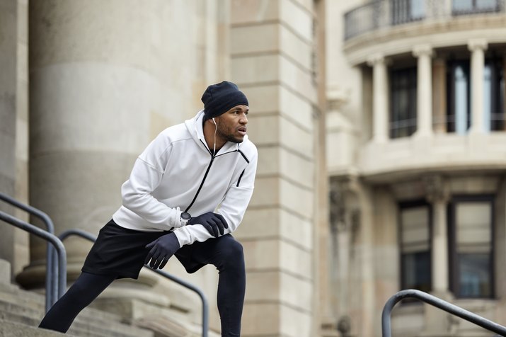 Determined man exercising on steps in city