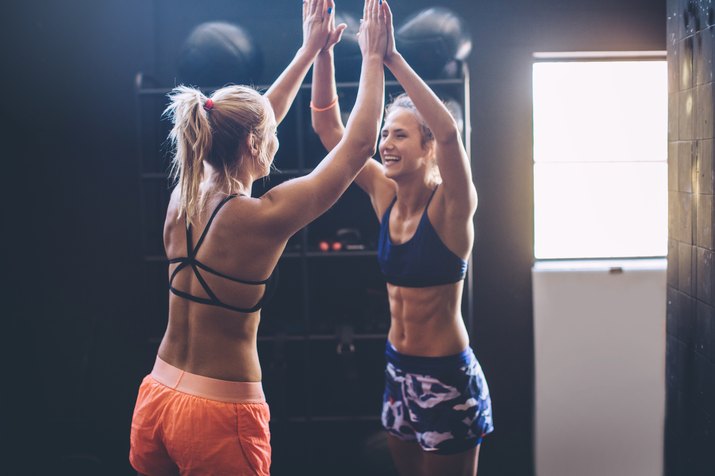 two girls congratulating each other on hitting their fitness goals