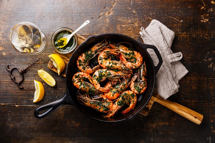 Tiger prawns roasted on frying pan and wine