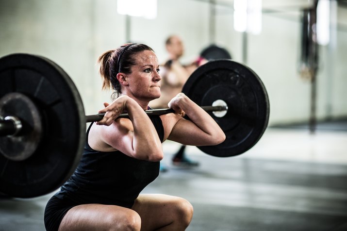 Woman doing front squats in a CrossFit workout