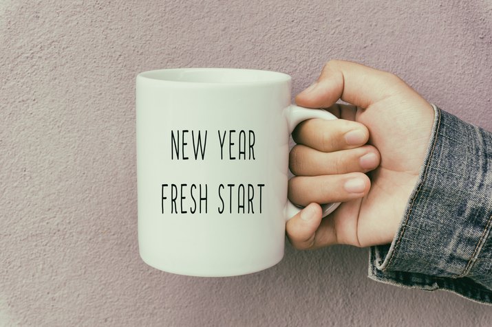 Hands Holding a Coffee Mug With Text New Year Fresh Start