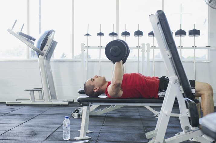 Middle Eastern man exercising in health club