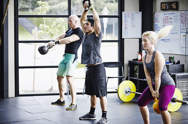 People doing a CrossFit workout with kettlebells