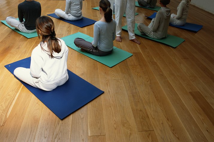 Women with cross legged in yoga class