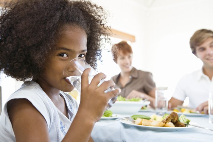 Girl drinking milk at dinner