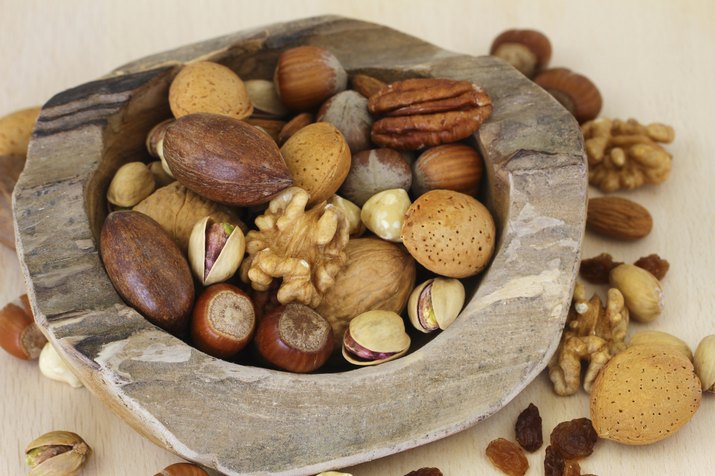 Nut variety in teak root bowl