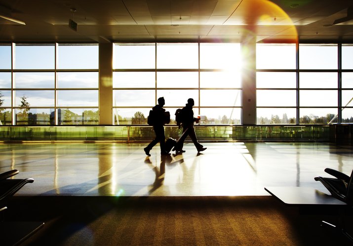 Silhoetted travelers at airport