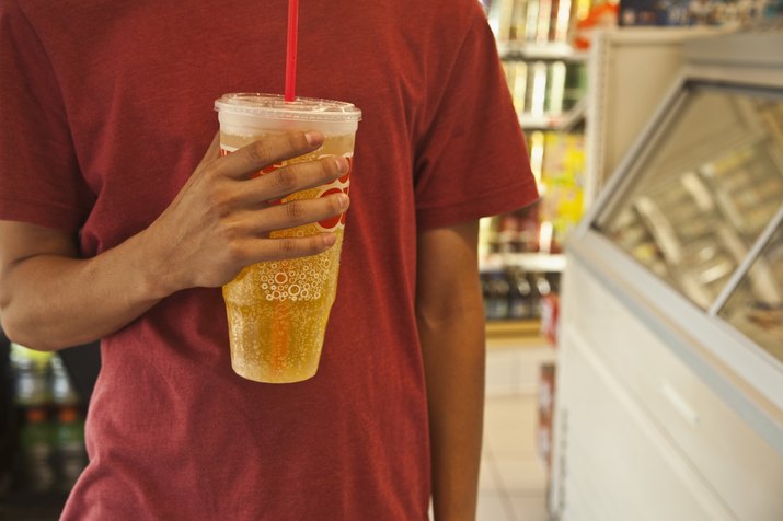 Caucasian man holding soda