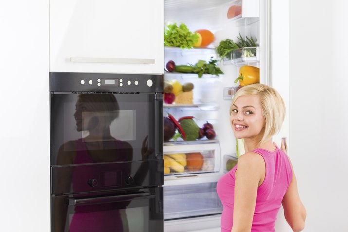woman refrigerator open door