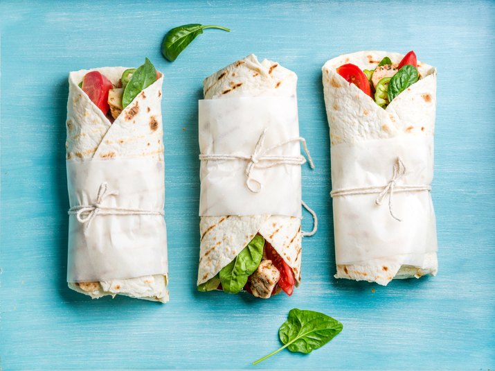 Healthy lunch snack. Tortilla wraps with grilled chicken fillet and