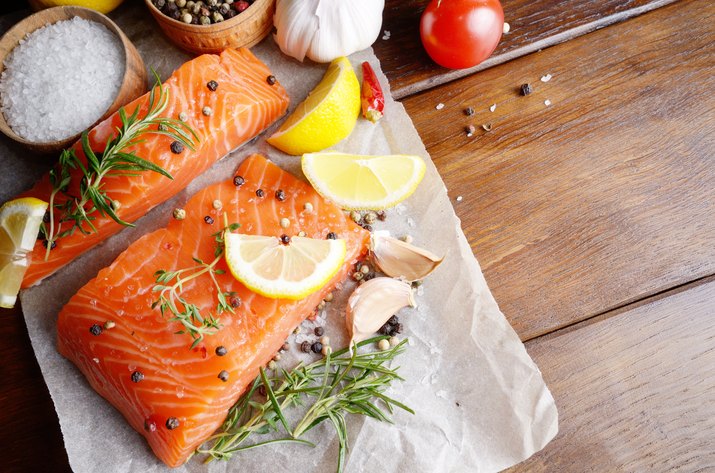 Raw salmon on baking paper for muscle building diet