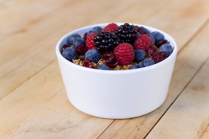 bowl of fruit and Granola on wooden table