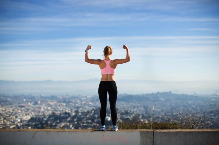 woman flexing overlooking the city