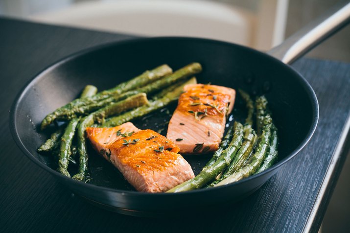 salmon and asparagus in pan