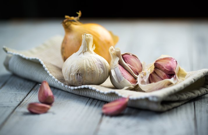 Fresh garlic on wooden background.