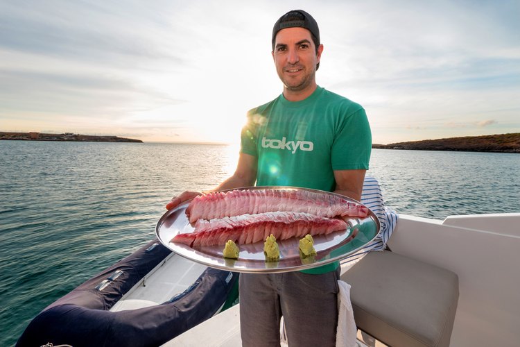 Omega Blue co-founder and executive chef Cody Requejo with a platter of Baja Kanpachi sashimi.