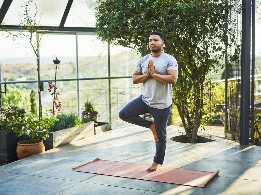 adult doing the tree pose balance exercise, as a natural remedy for vertigo