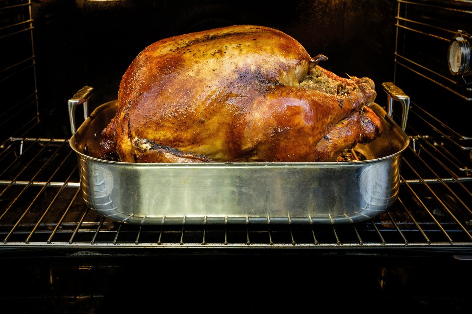 cooked turkey in roasting pan inside oven